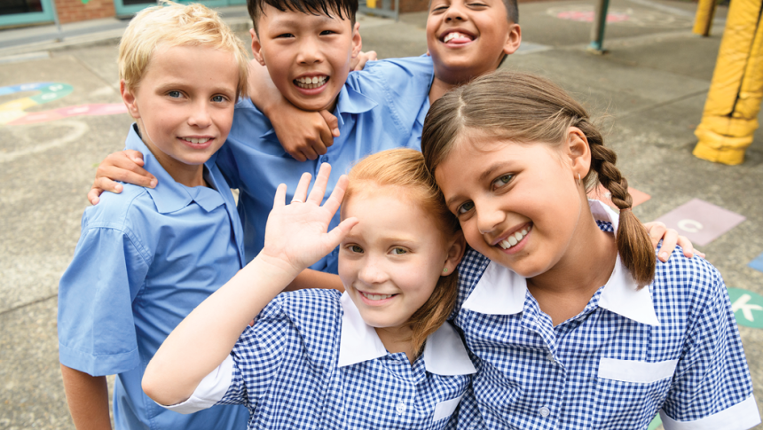 Group of five smiling primary school students 