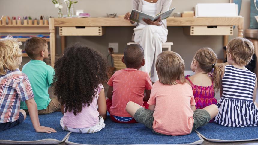 teacher reading group of children book