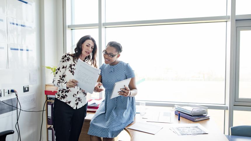 Two adults discussing documents