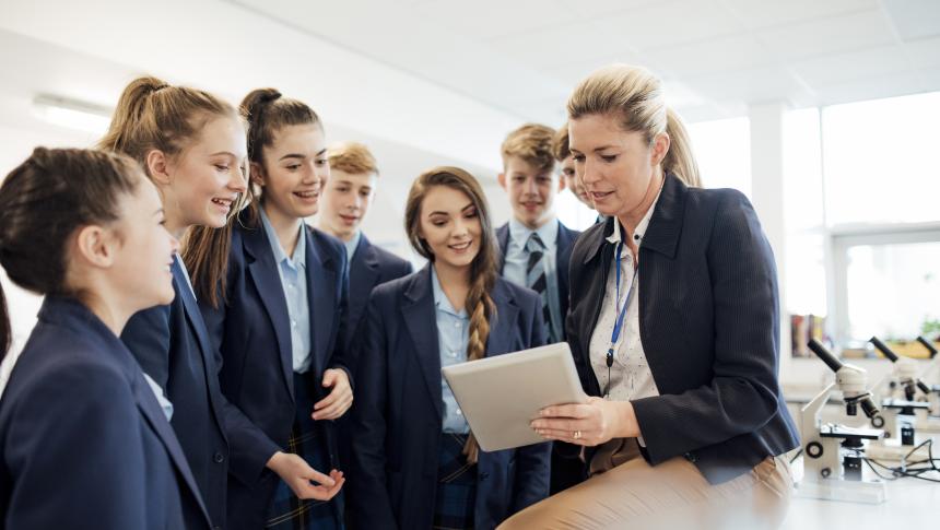 Teacher and students looking at a mobile device