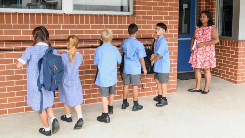 Students line up outside a classroom 